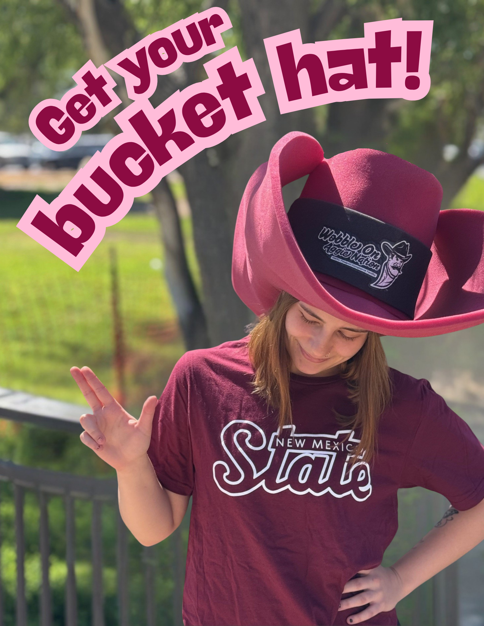 Image of a student waering a large bucket hat with the words Get Your Bucket Hat